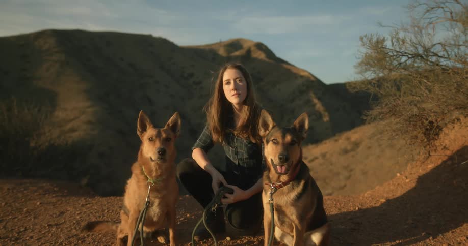 Person posing with dogs