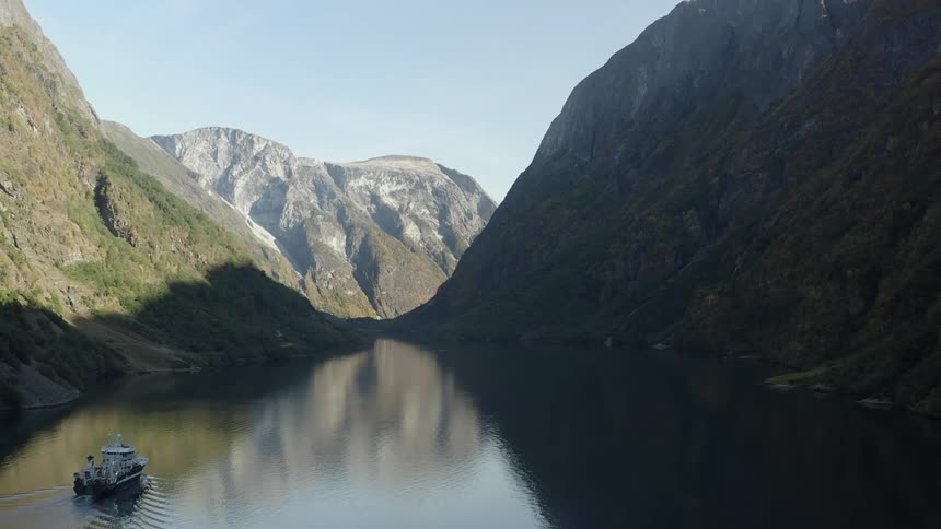 A boat travels on the mountain lake