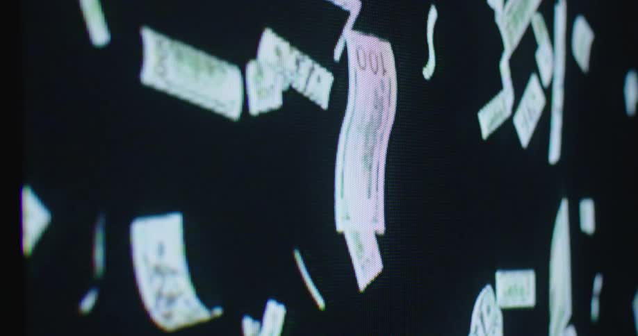 Digital screen shows paper money falls down screen against black background