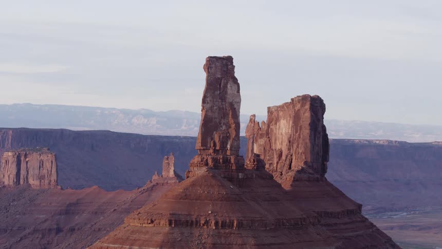 Rock towers over the butte in a mountain range on the desert at morning
