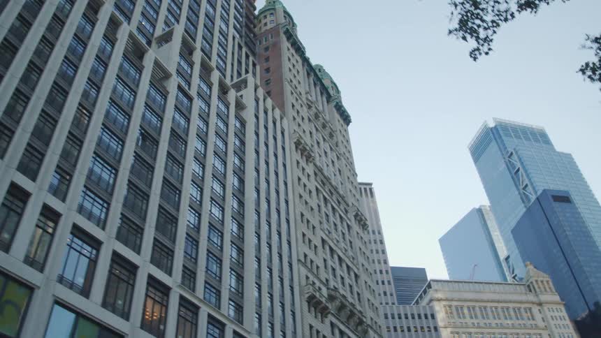 The tall buildings are high in the sunny sky