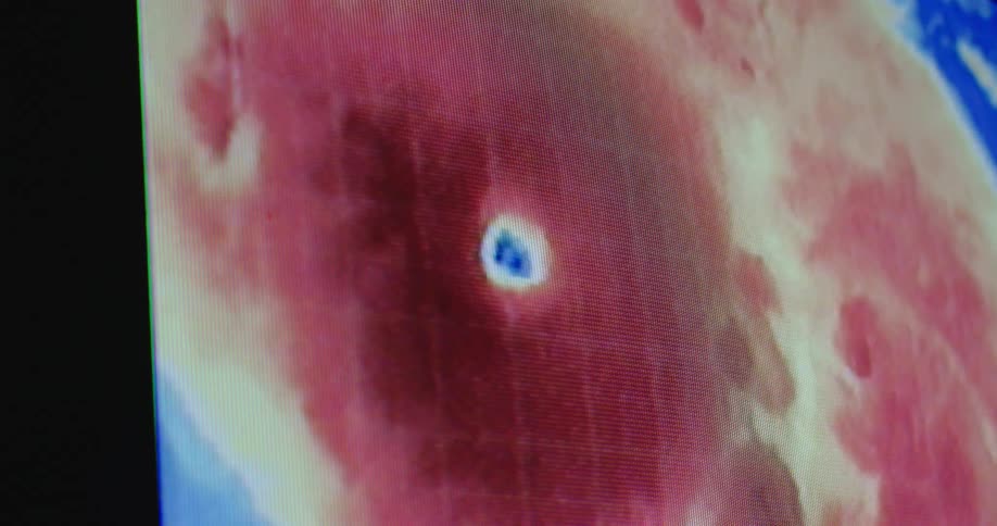A twirling twisting weather pattern colorfully displayed on a screen