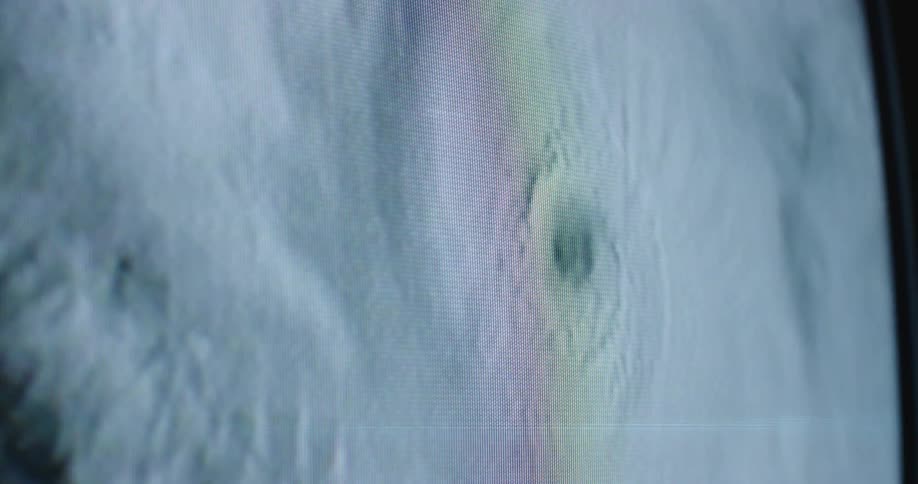 The eye of a hurricane shown on a television screen