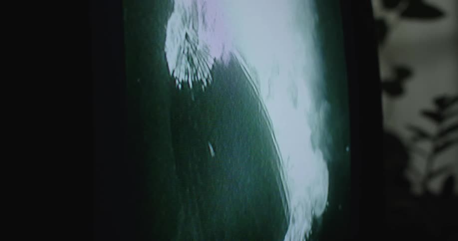 Close up of a television screen showing vintage footage of the hindenburg disaster