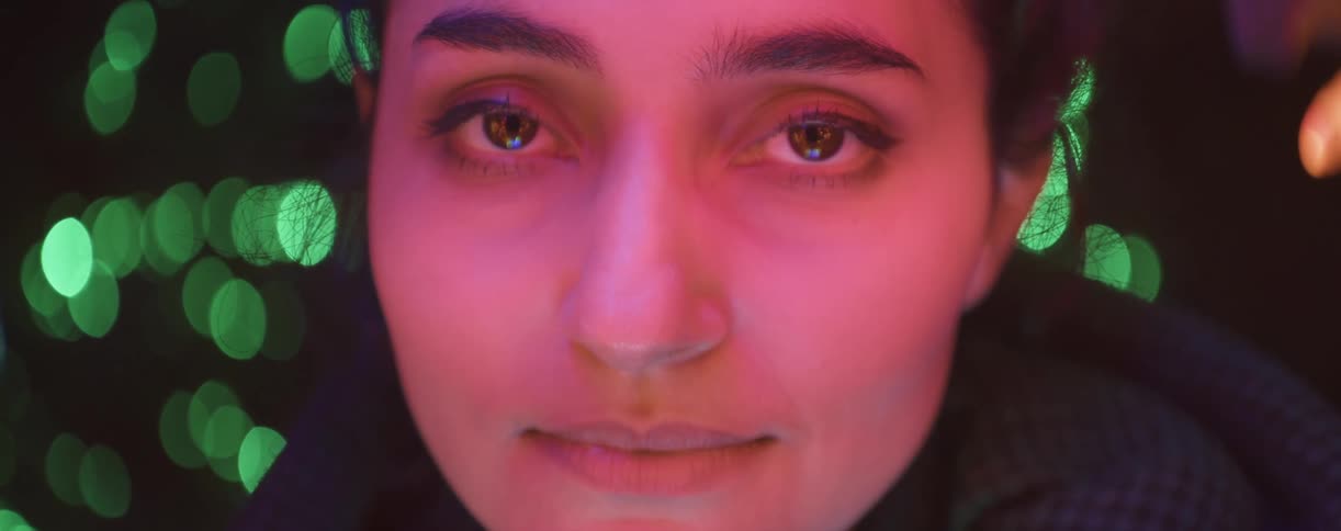 A woman is blinking as she looks forward