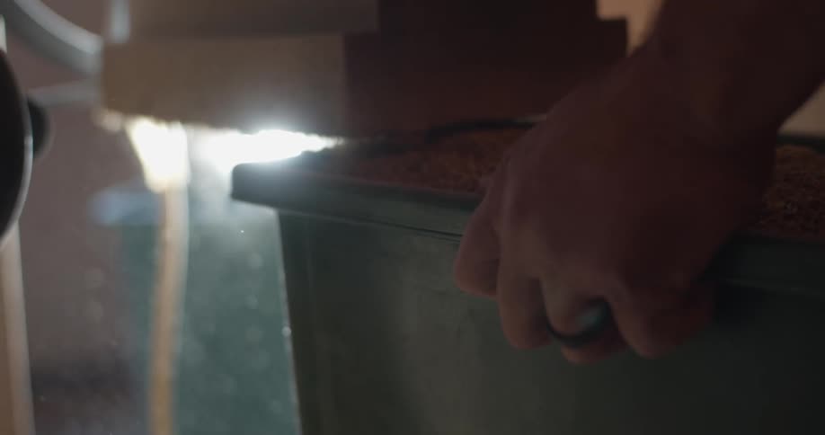 A man removes a bin of barely