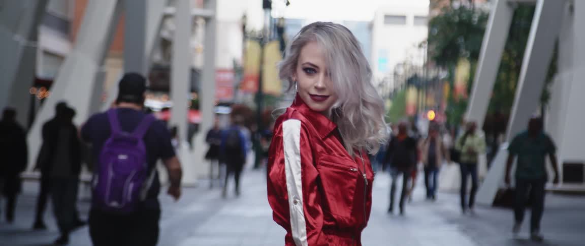 A model spins around then smiles