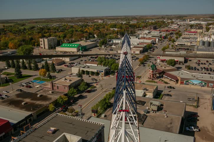 The crane turns high above the town