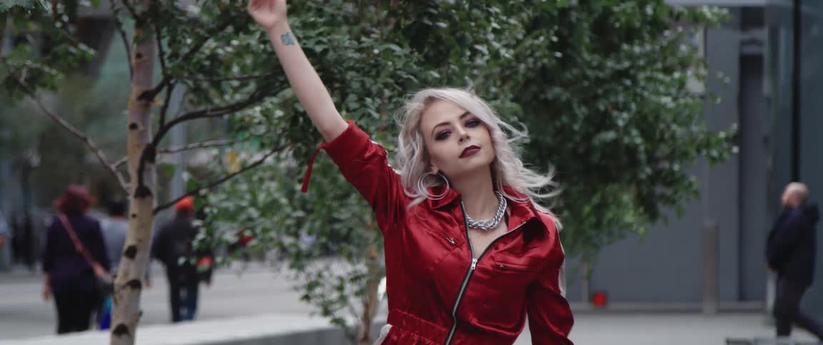 A model waves her arm as she poses