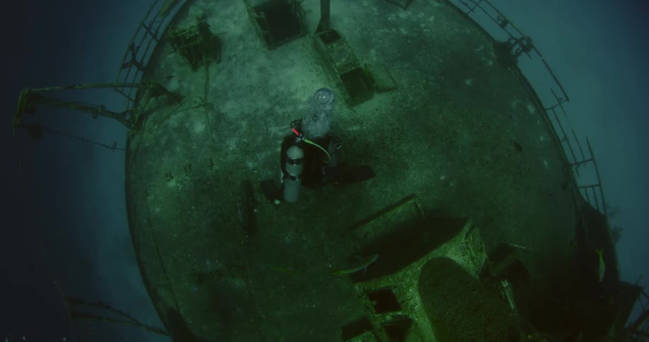 Scuba diver exploring some wreckage
