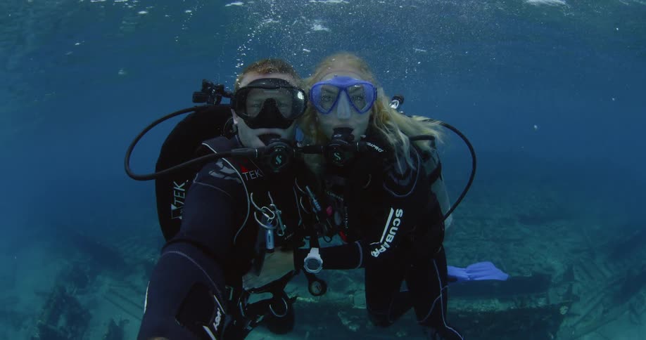 Scuba divers film themselves near the surface