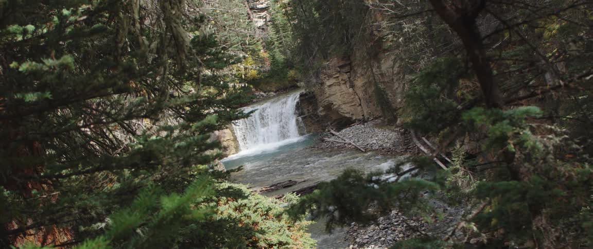 A waterfall flowing in to a river