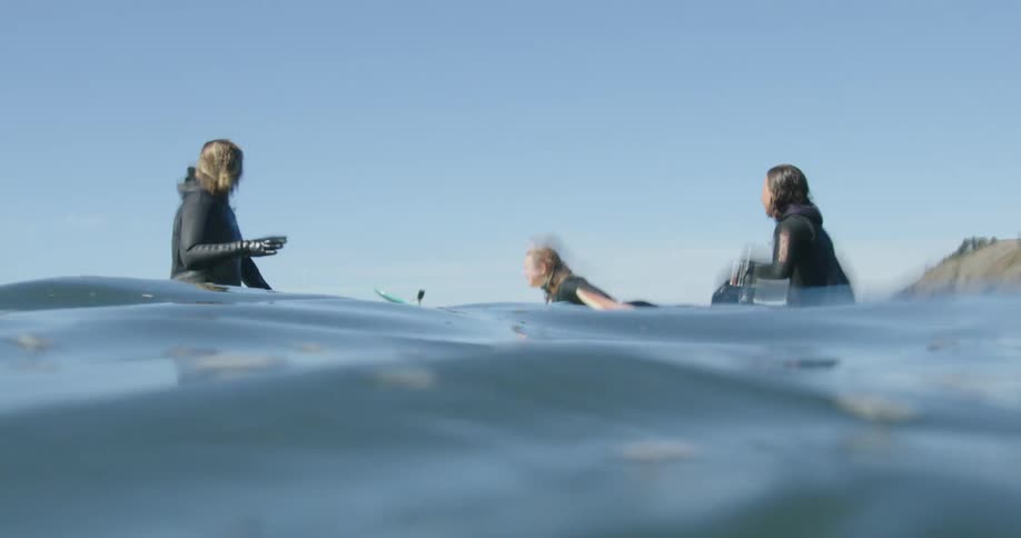A group of women out on surfboards in the ocean