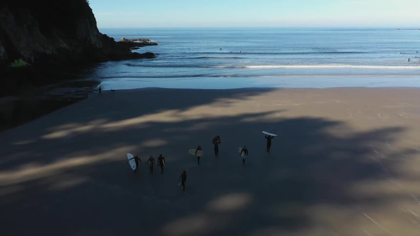 People walking back from surfing