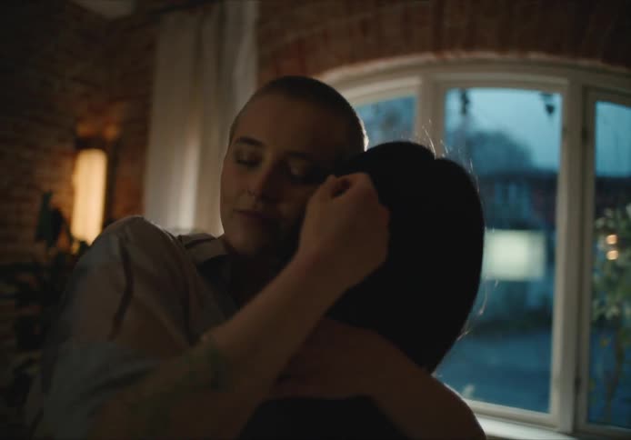 Two women hugging each other