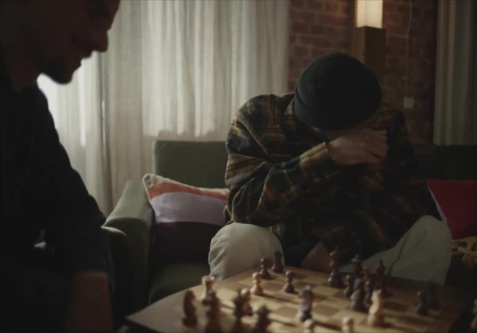 Two men are playing chess together