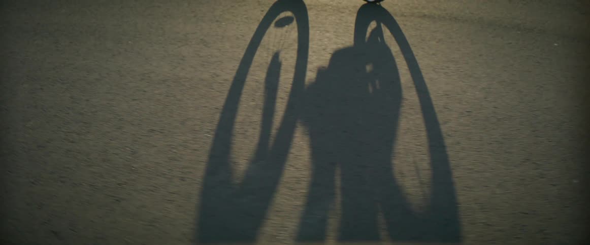 A view of a shadow of a bicycle outdoors