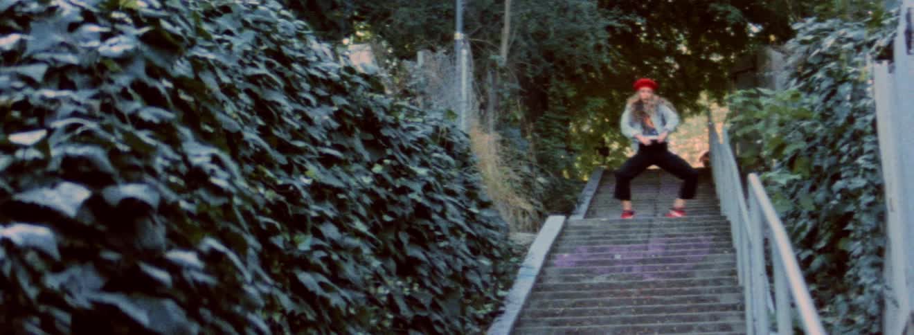A woman is dancing up the stairs