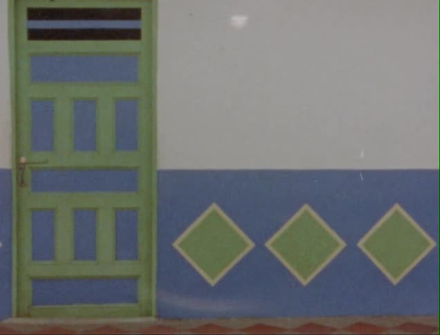 Wall of a house on a small town decorated with colorful patterns caught on vintage film