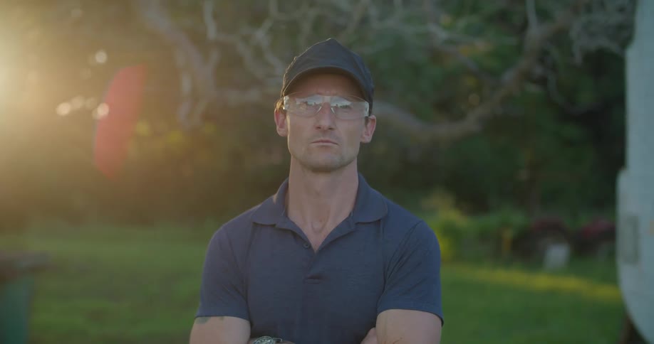 A man is standing with his arms folding