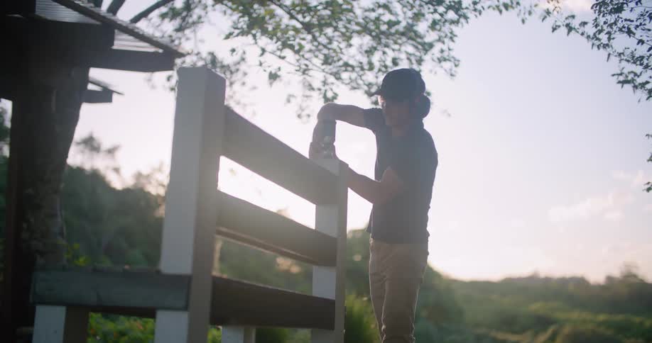 A man is fixing the bench in his yard