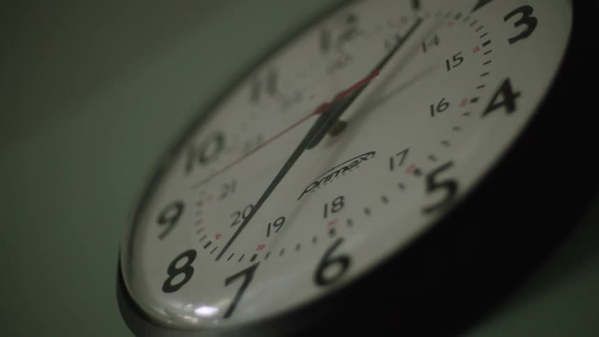 Red second hand move across face of wall clock