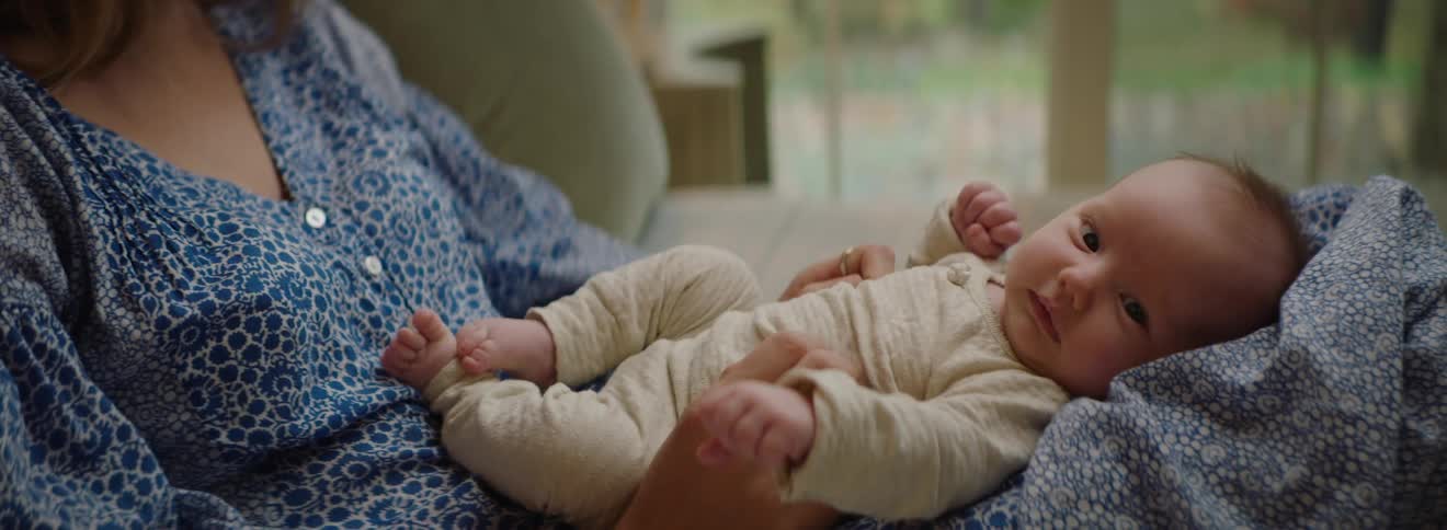 A mother sits with her son in her lap