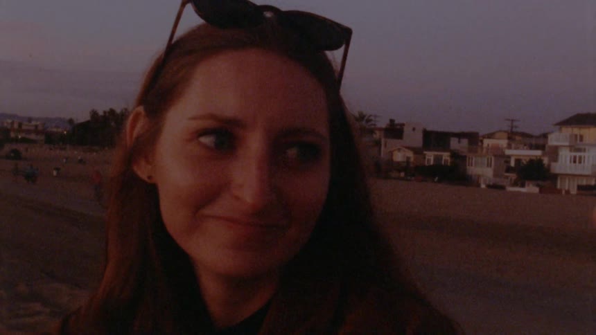 Two friends are sitting outdoors together at dusk