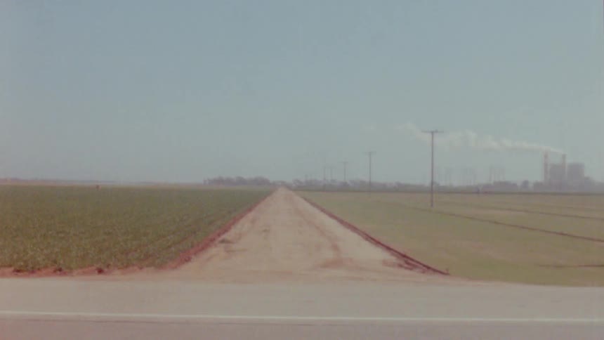 Dirt road between fields in the countryside caught on vintage film