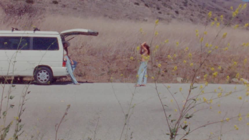 People taking pictures near car