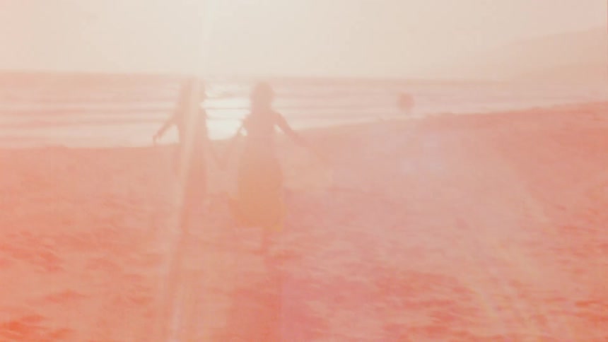 Two women are jogging on the beach together at dusk
