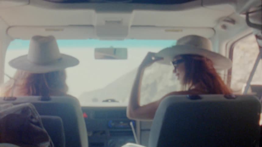 Two women dancing and driving at the same time