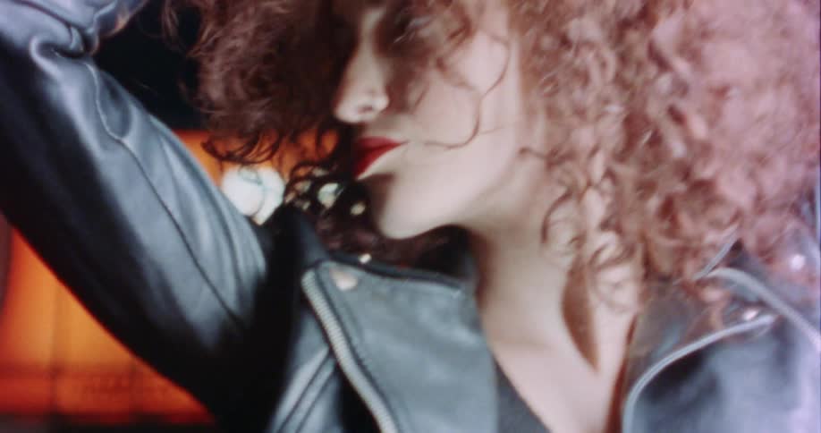 A woman poses under a light