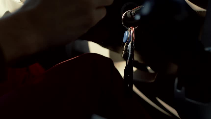 The hand of a person on a steering wheel as they drive
