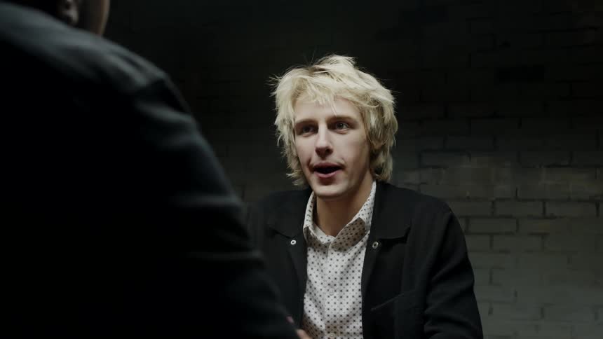 Two men talking to each other in a room