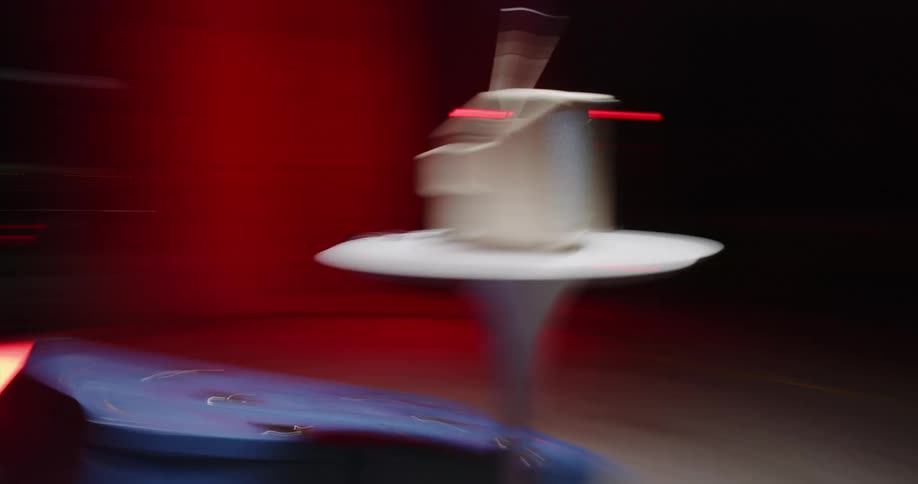 Blue lockers stacked on the floor beneath a round table with a television set playing static