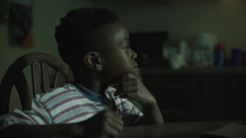 A child sits at the table talking
