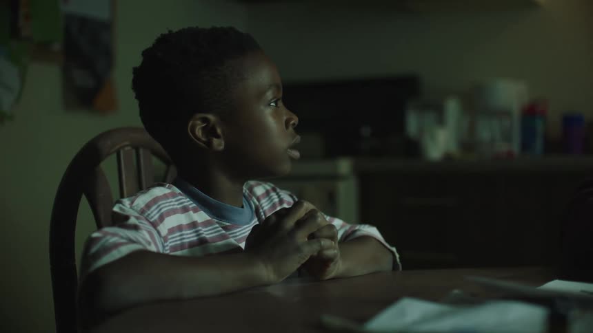A child sitting at a table talking