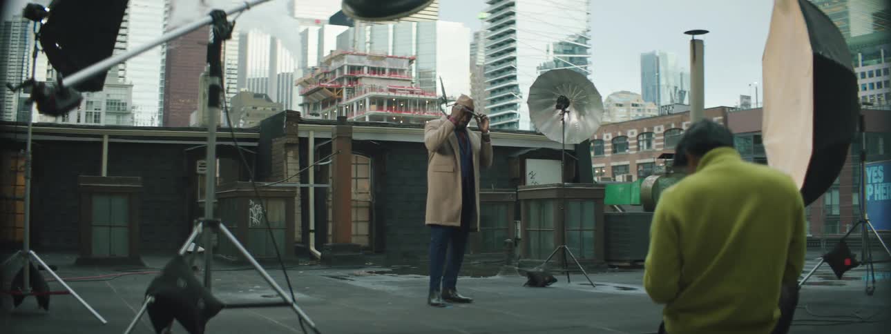 A man is posing on the roof for photographs