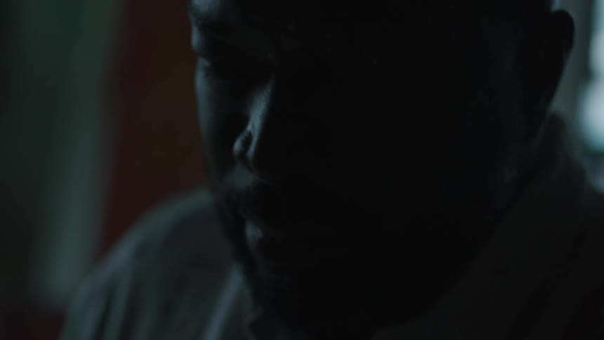 A man is standing in a room and light is flashing