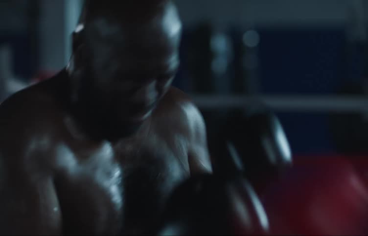 Two men are wearing boxing gloves and are boxing in a ring
