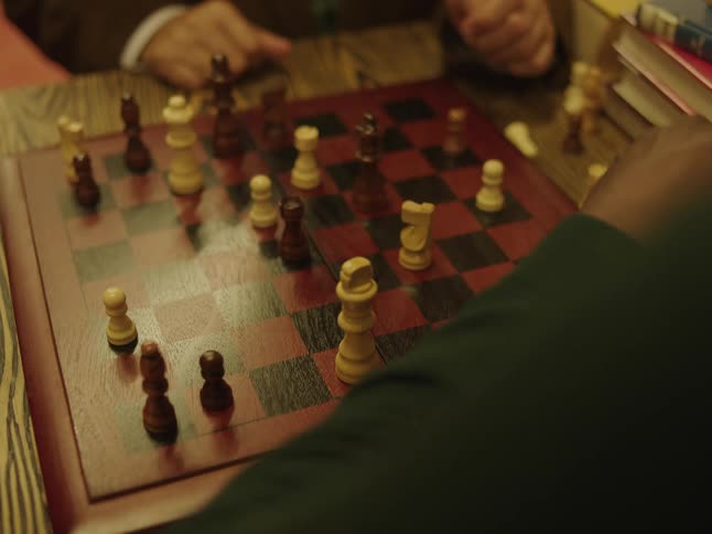 A man playing chess in a room