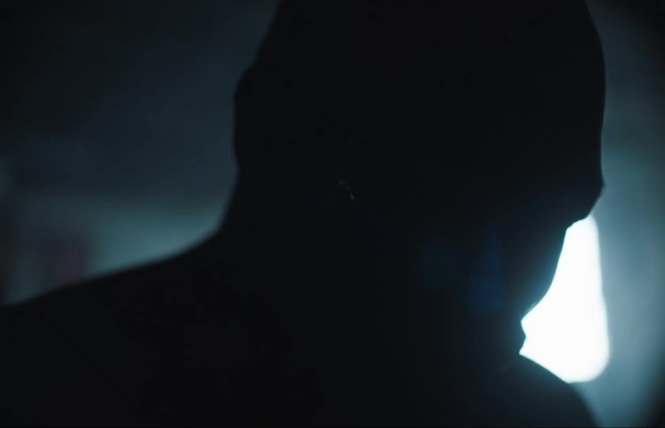 The lights flash on the bleeding man