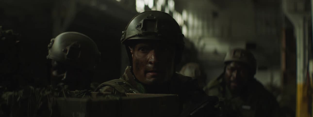 A soldier throws a grenade from cover