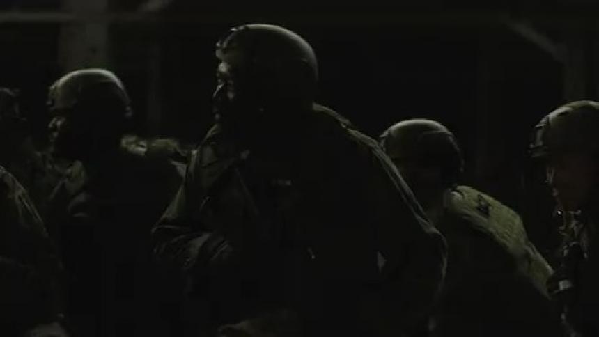 Soldiers brace for an explosion in the dark