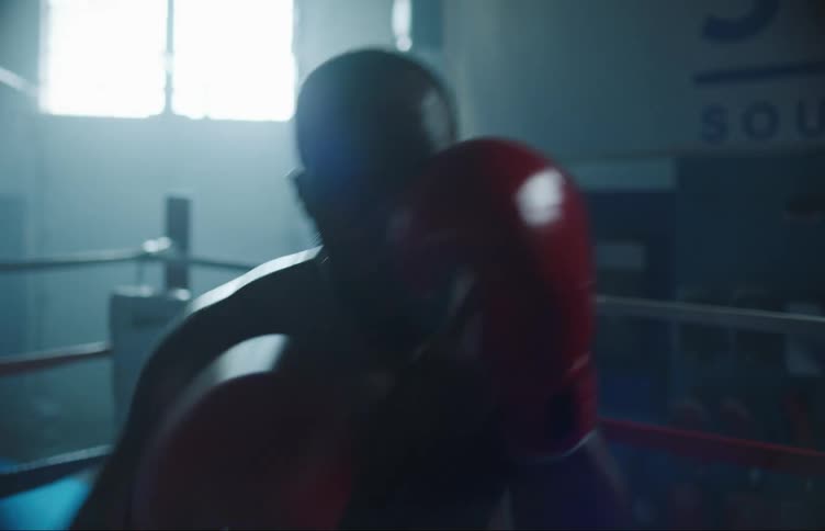 A man throws punches as he boxes