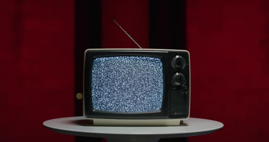 A view of a vintage tv with static on the screen