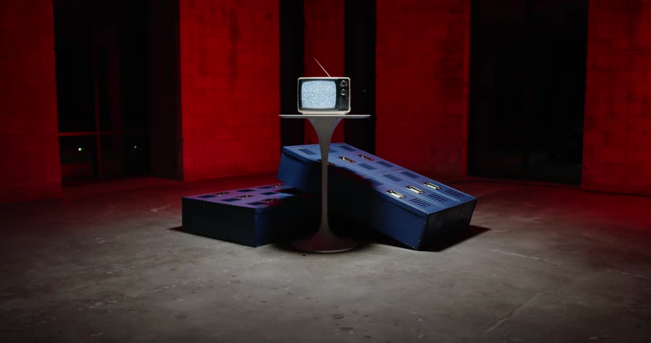 Static plays on a television sitting on a pedestal table in a dim room