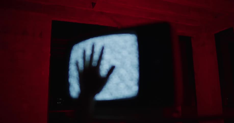 A person is touching a television screen