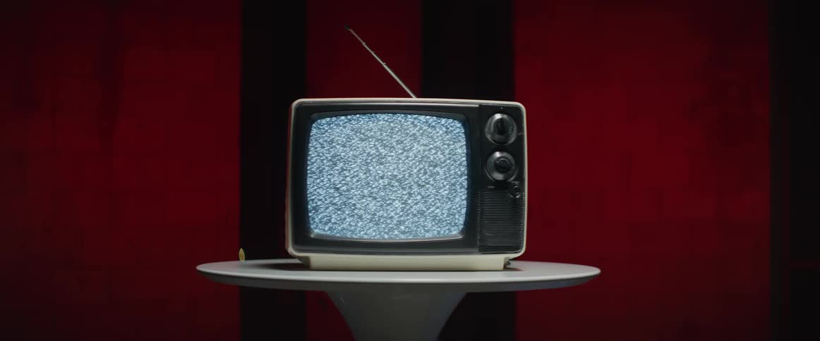 The small television is displaying static